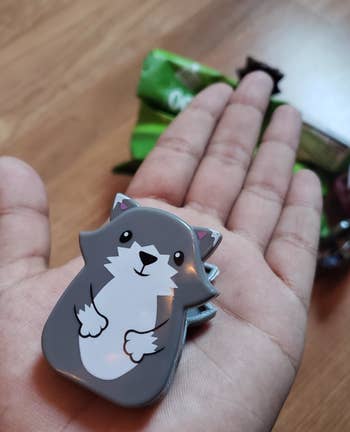 Reviewer holding animal-shaped chip clip