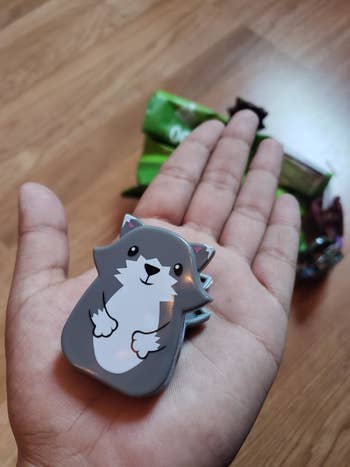 Reviewer holding animal-shaped chip clip