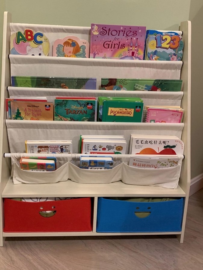 bookcase with red and blue drawers on the bottom and fabric pouches