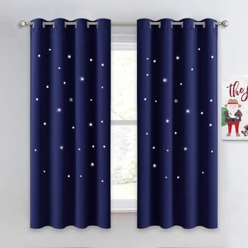 Blackout curtains with star cutouts placed on window