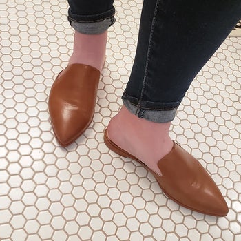 reviewer wearing the brown backless flats