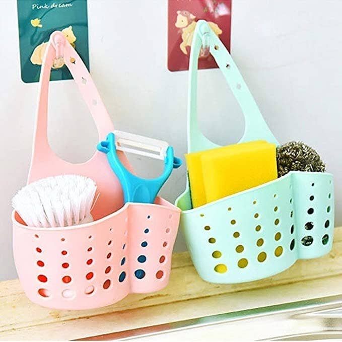 Sink caddy with cleaning brushes in it.