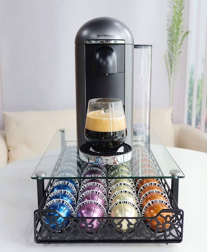 A nespresso pod organizing drawer with a glass top 