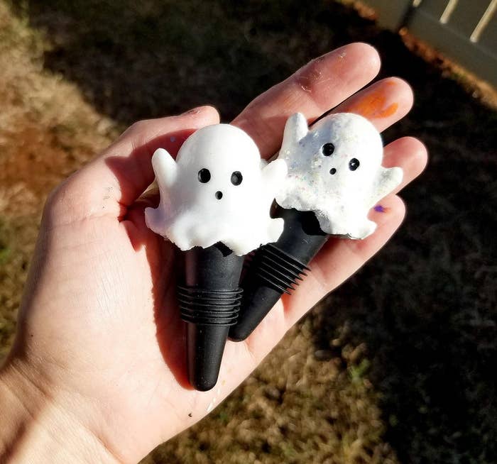hand holding the ghost bottle stoppers
