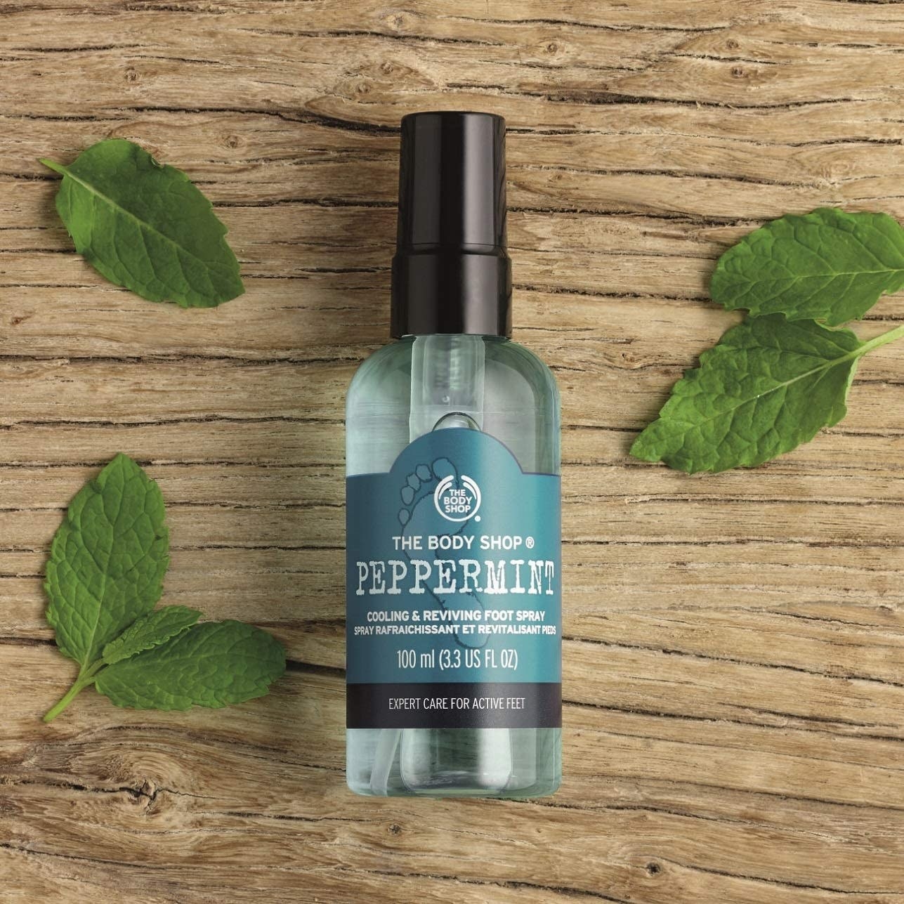 A bottle of foot spray on a wooden background