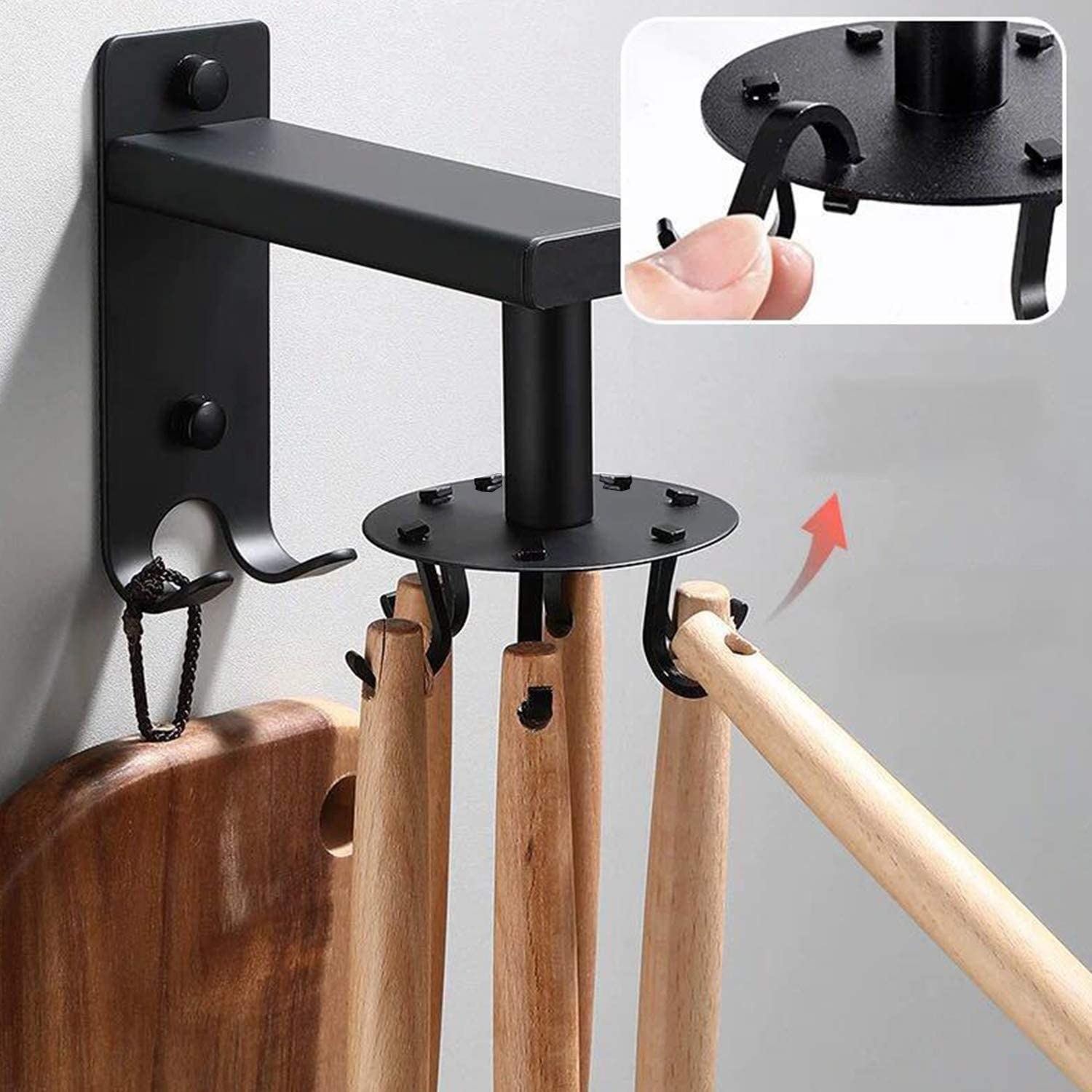 person putting a wooden utensil on the hook