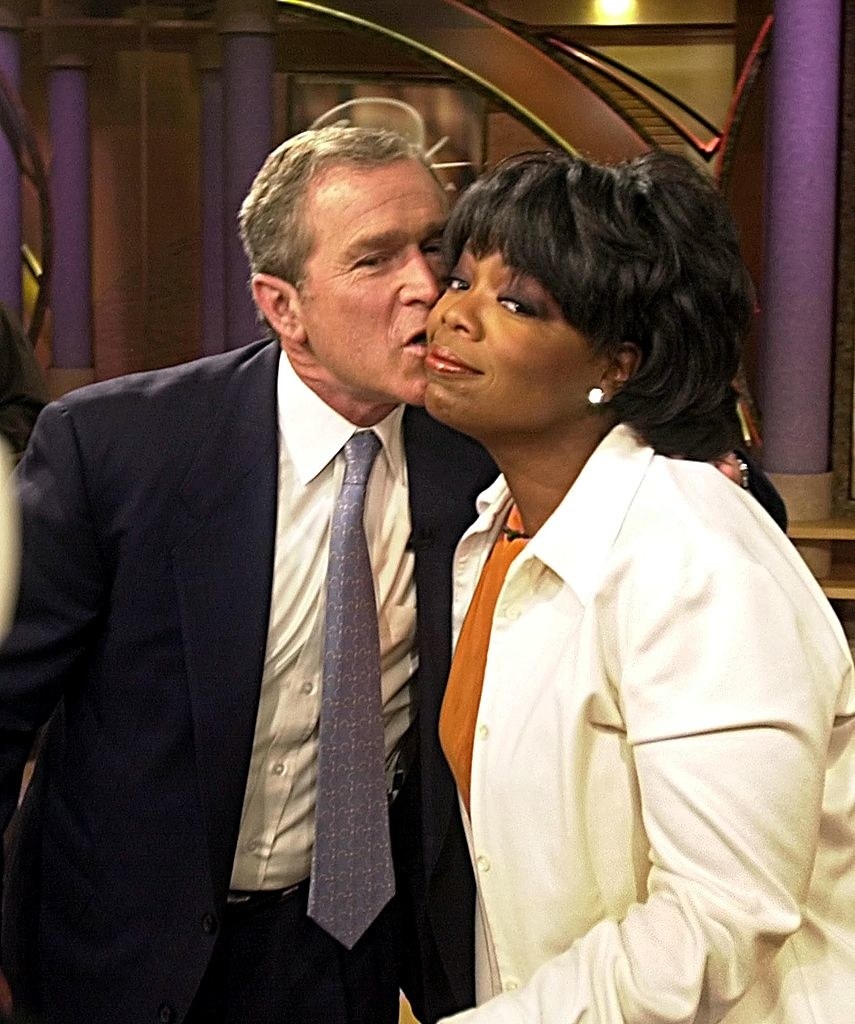 oprah getting a kiss on a cheek from prez bush