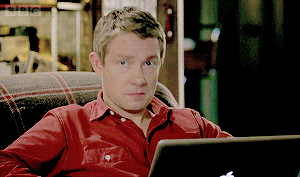 Martin Freeman looks up from his laptop with a shocked &quot;oh&quot; face, then looks back down with a confused, furrowed brow