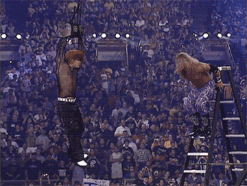 Wrestler Edge jumping off a ladder and spearing a dangling Jeff Hardy.
