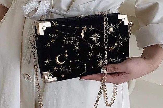 model holding the black purse with gold chain