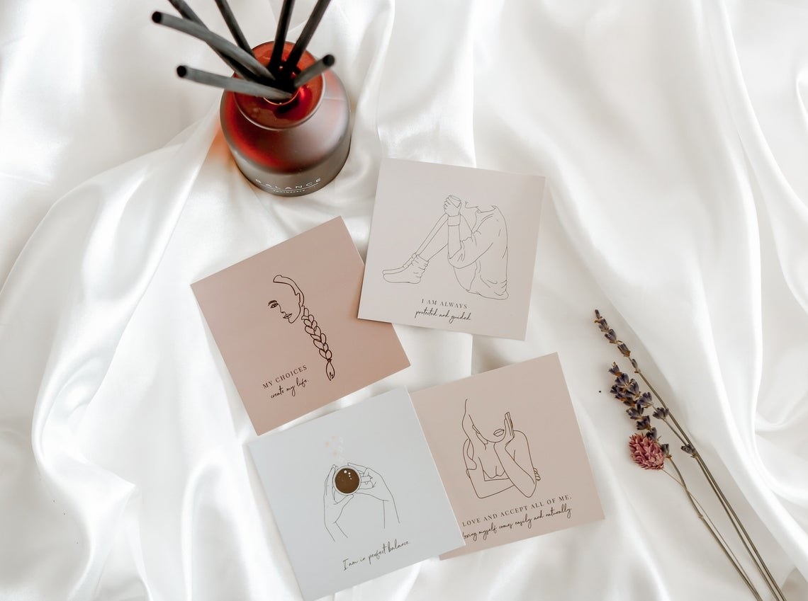 Four square cards with line drawn minimalist illustrations and affirmation phrases 