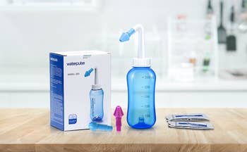 Sinus rinse bottle next to included items