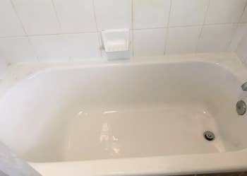 A customer review after photo showing that same tub with all the stains removed