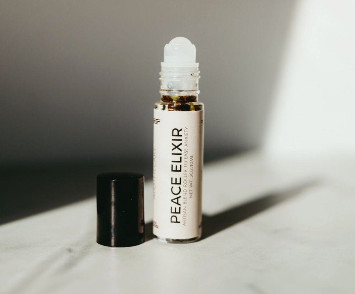 Small roller bottle with "Peace Elixir" written on the label