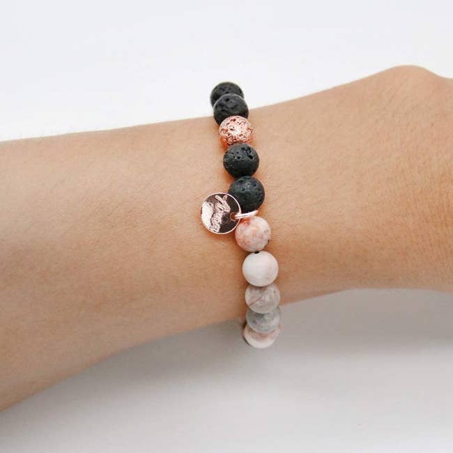 Bracelet with round stones. It stretches on and the lava rocks can be filled with the oil provided