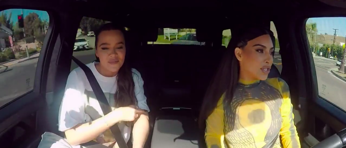 Khloé and Kim inside a car