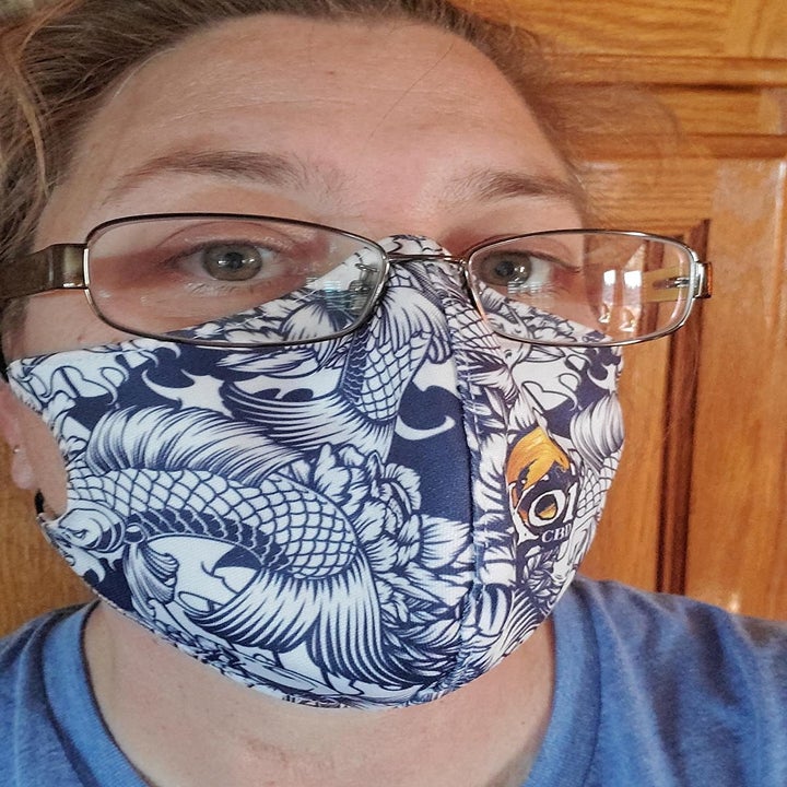 reviewer selfie; they're wearing a blue face mask with koi fish and glasses that are not fogged up