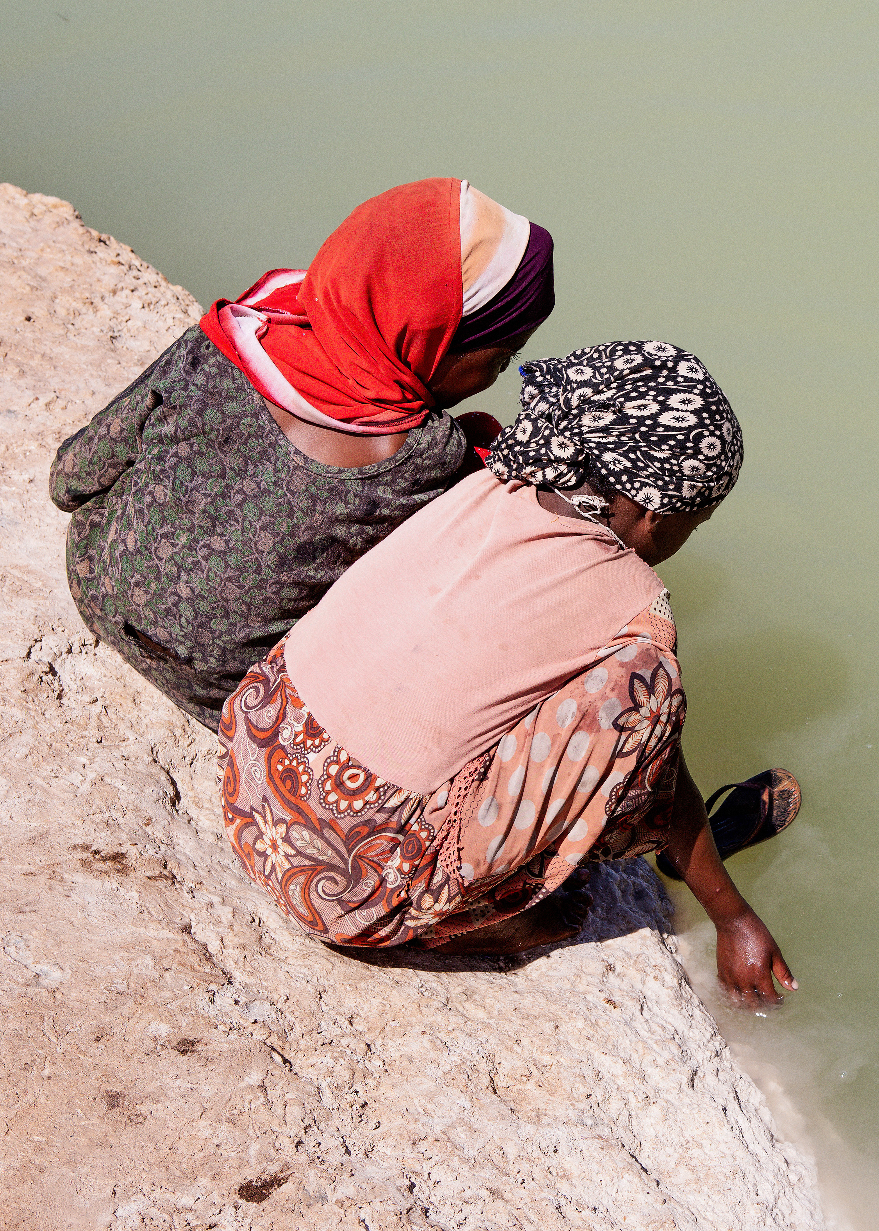 Two women looking into the water