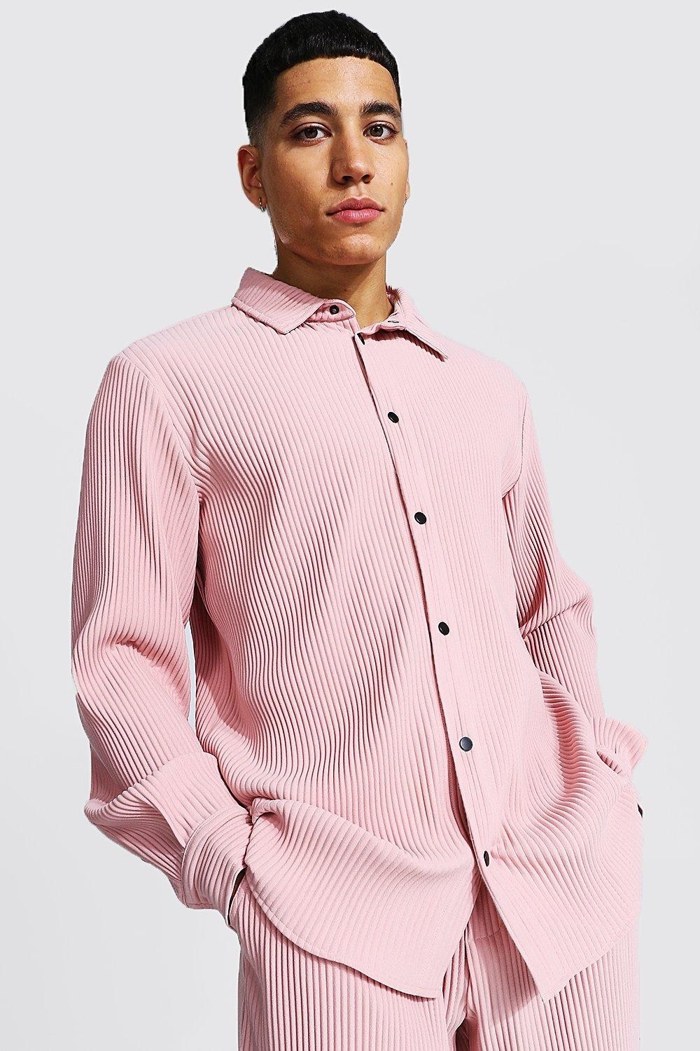 Model in a pleated pink shirt and matching pants