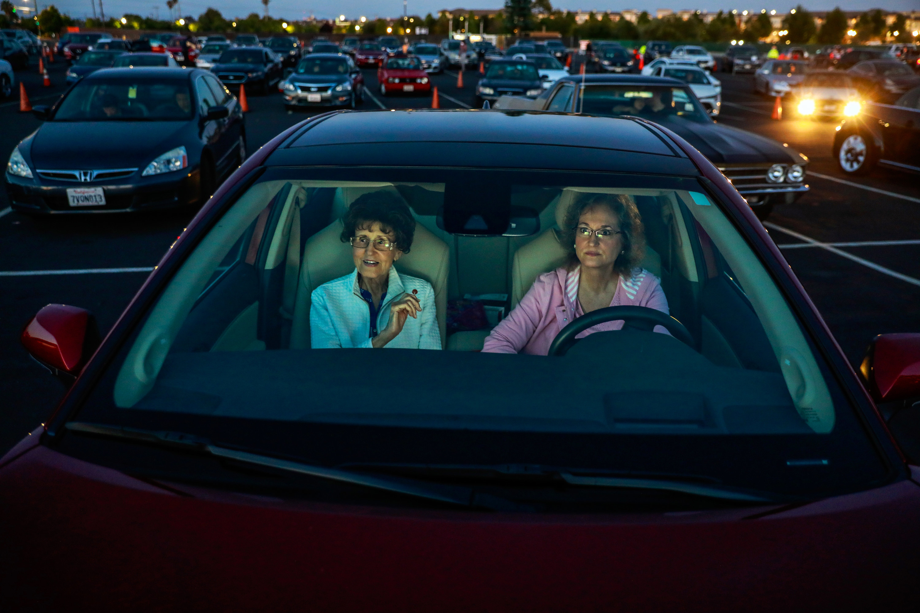 Two women in a car in a drive-in movie theater parking lot