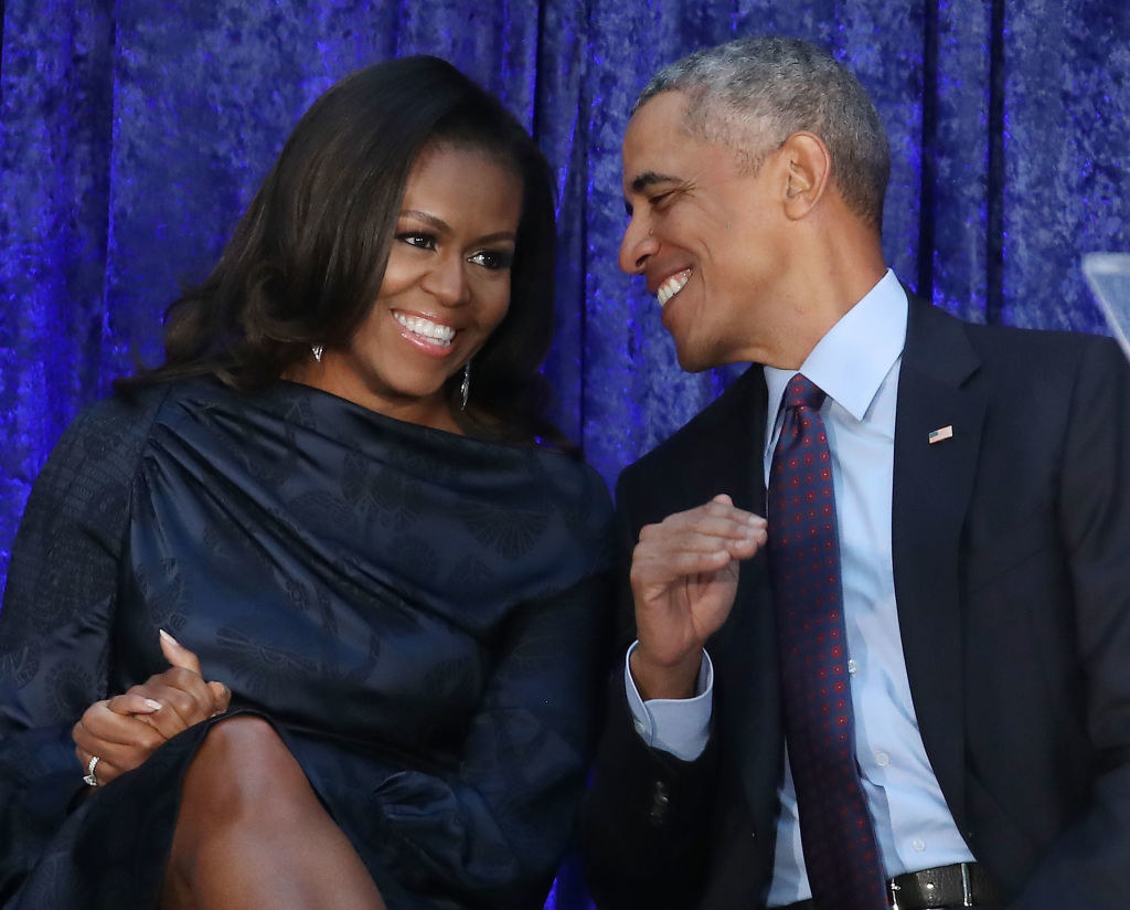 Michelle and Barack Obama smiling at each other