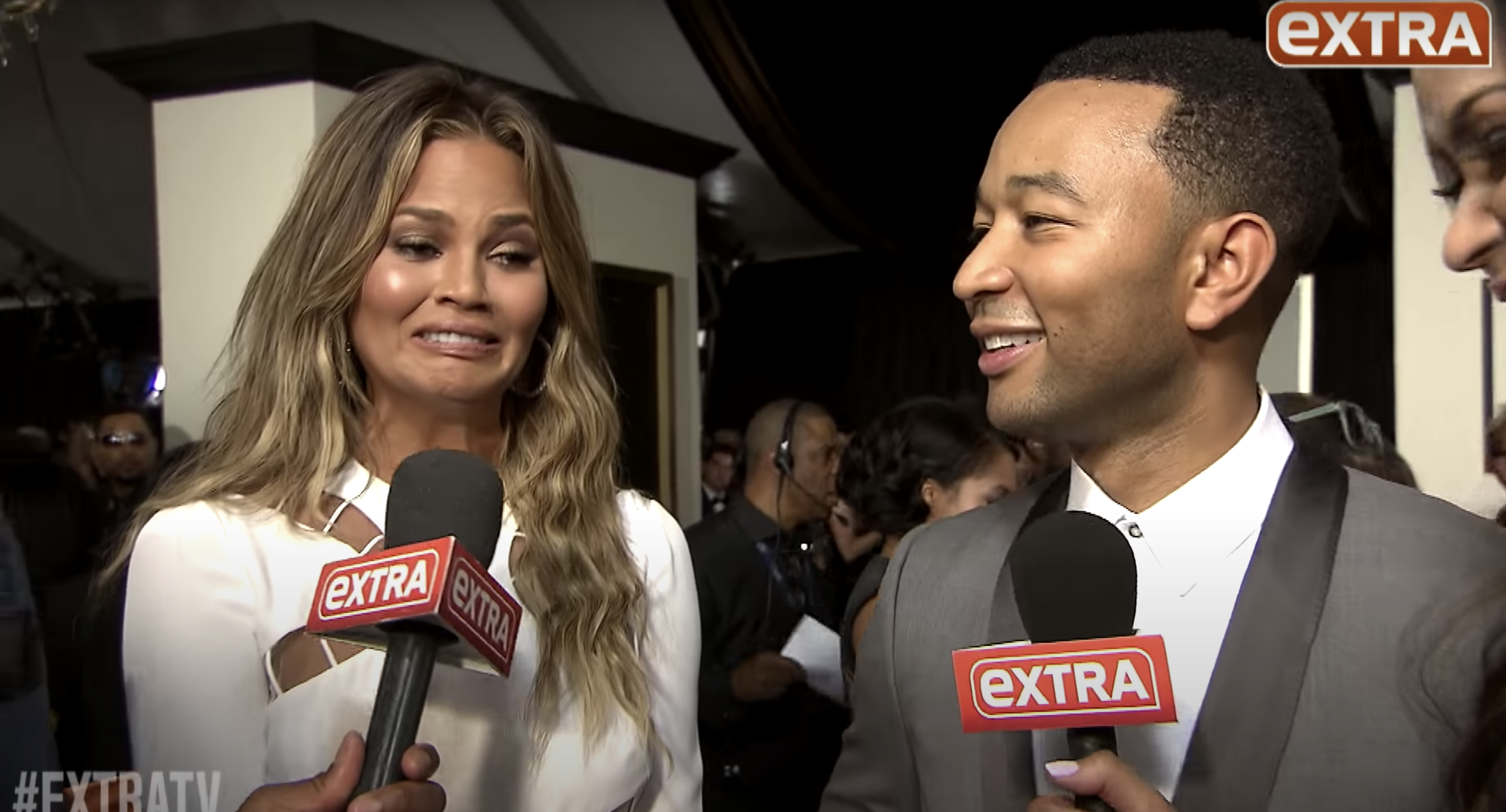 Chrissy and John being interviewed at the Grammys red carpet