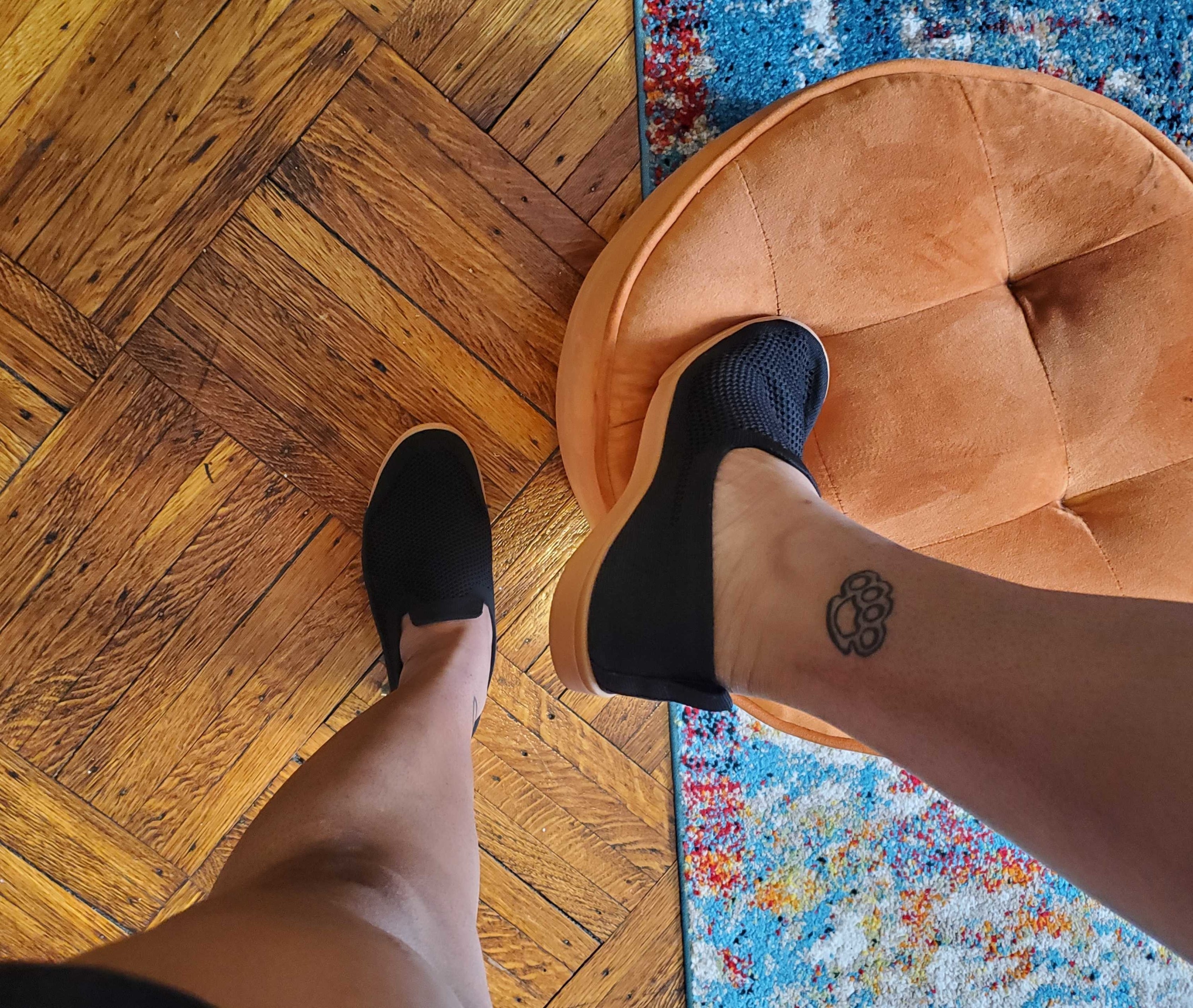 close up of buzzfeed writer taylor steele wearing the barton shoes in jet black gum in their bedroom
