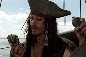 jack sparrow looking at a compass
