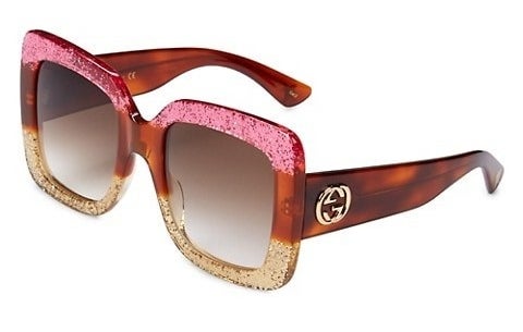 Plastic pink, brown, and tan sunglasses with Gucci logo
