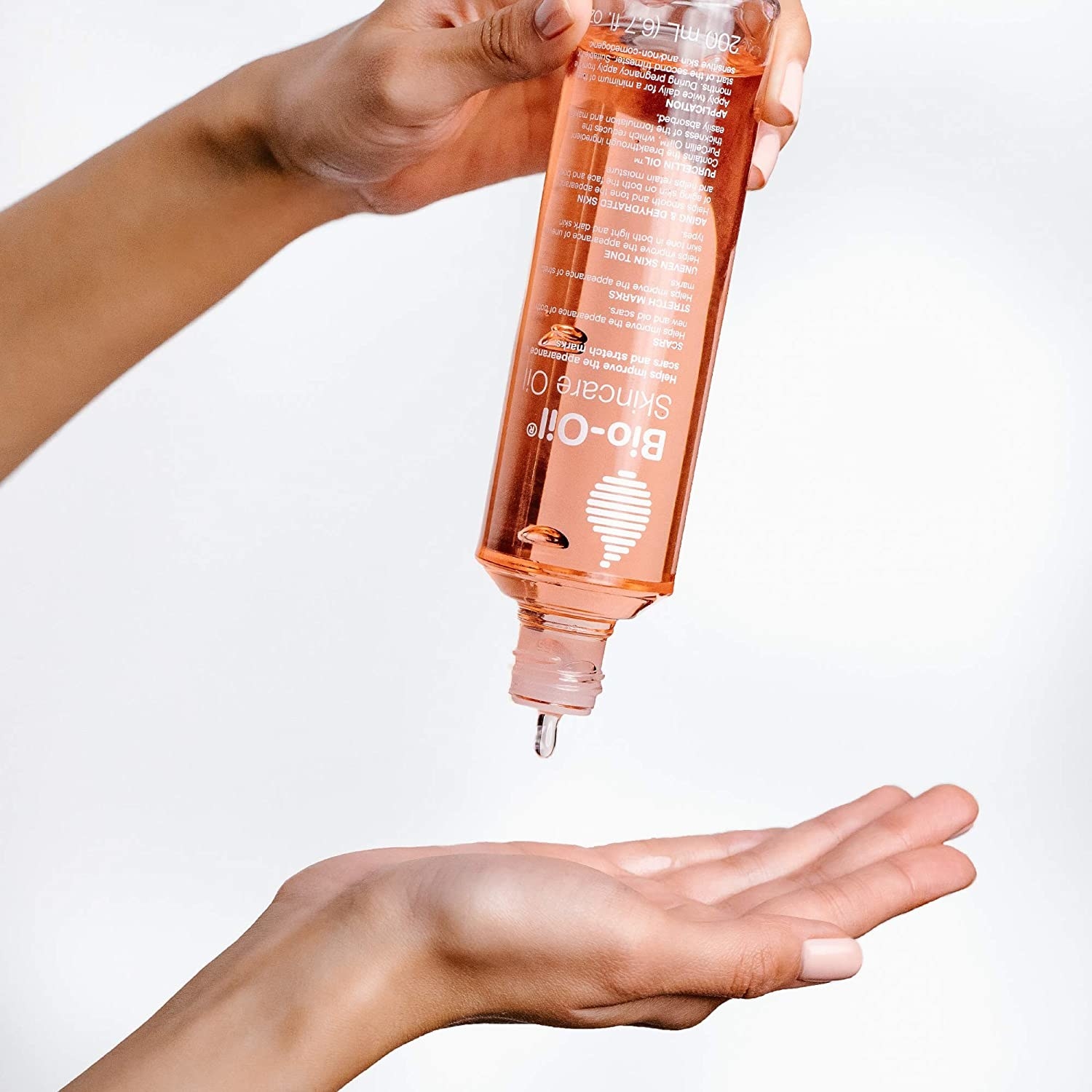 A model pouring bio-oil on their hands 