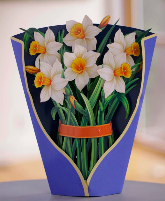 Paper bouquet of flowers standing upright on a table 