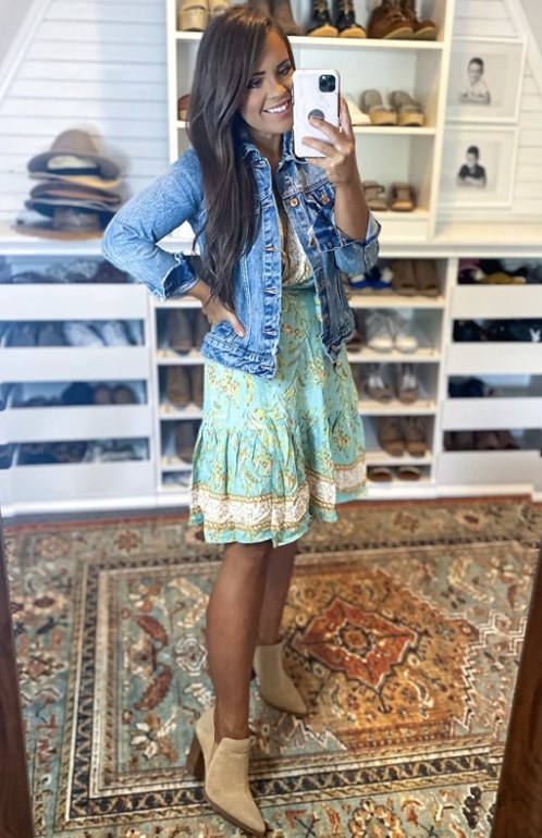 a reviewer wearing the dress with a denim jacket and booties 