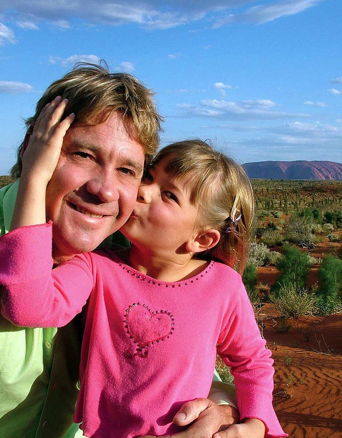 A photo of a young Bindi kissing her dad on the cheek