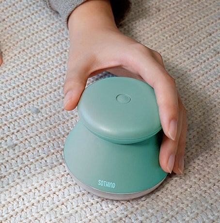 A person holding the fabric defuzzer