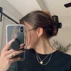 reviewer taking a selfie while wearing the black clip 