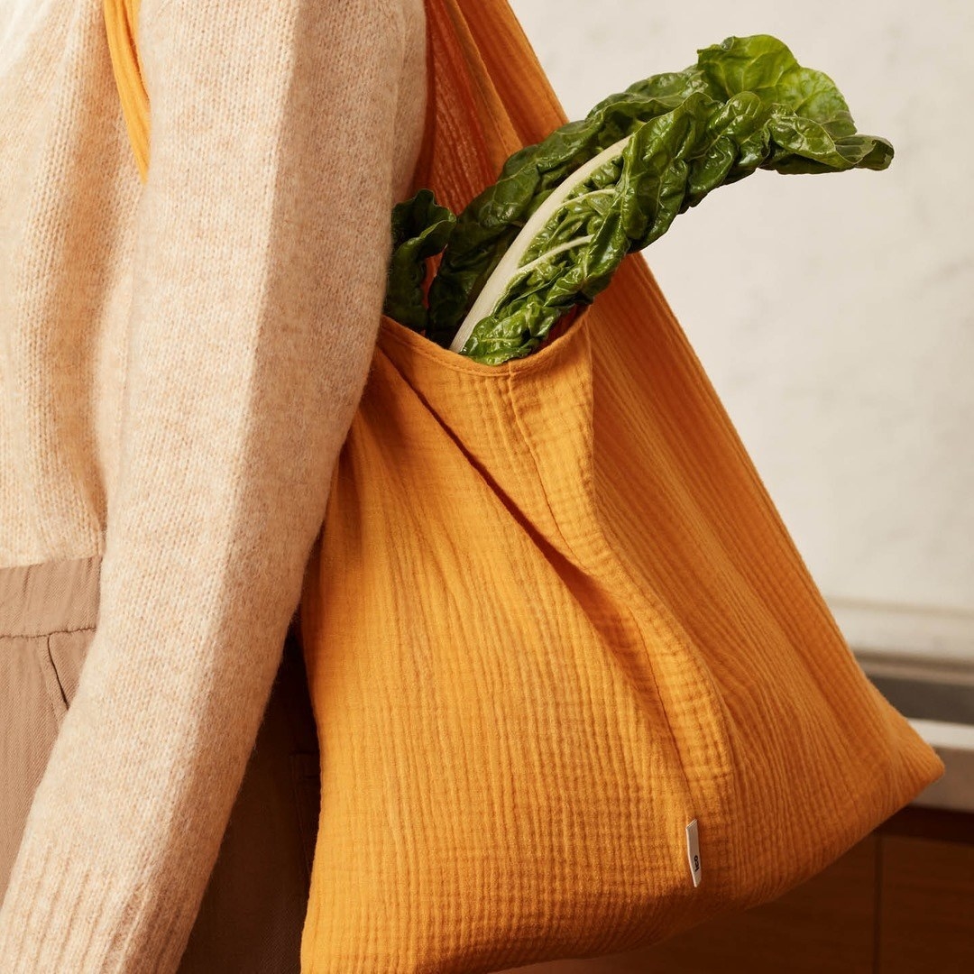 A person wearing the bag on their shoulder