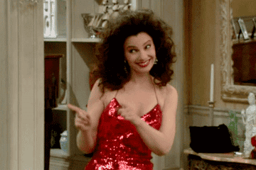 Fran in sparkly red dress pointing