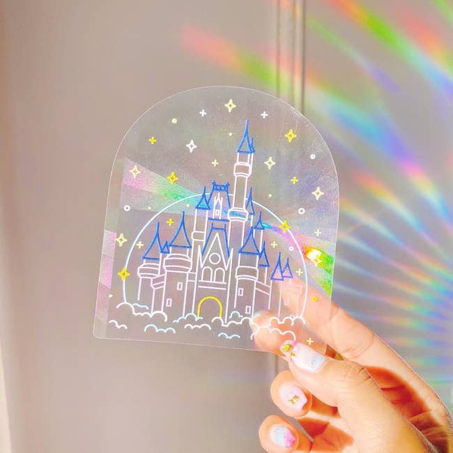 Sticker with illustration of Cinderella's castle that refracts light to create rainbows 