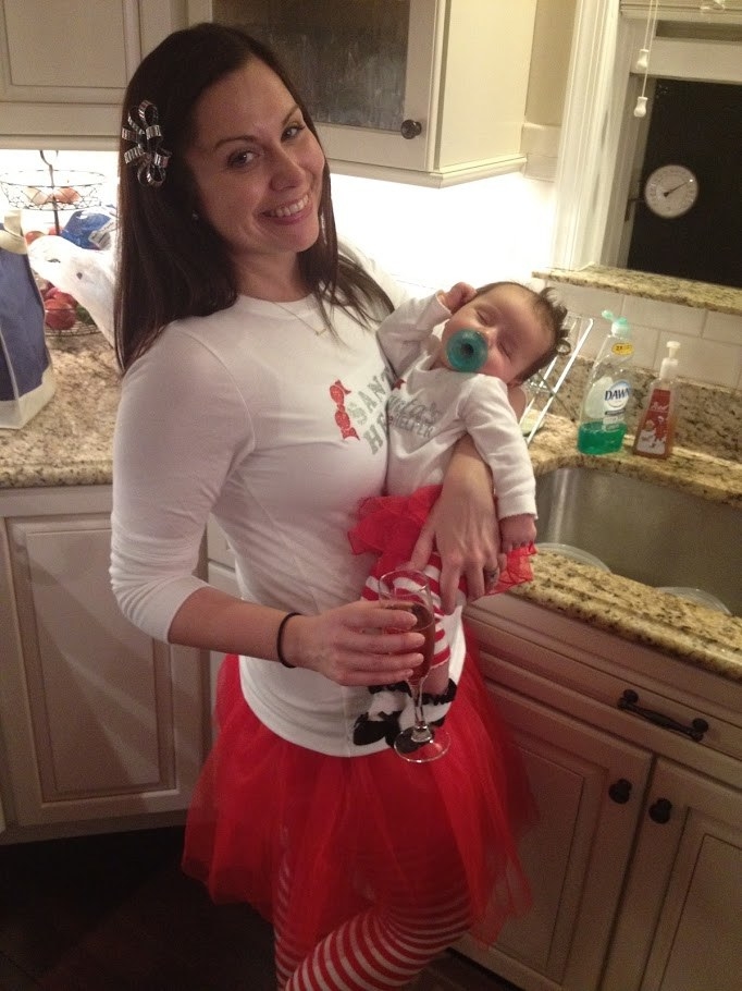 The author and her newborn dressed in matching Ms. Claus outfits