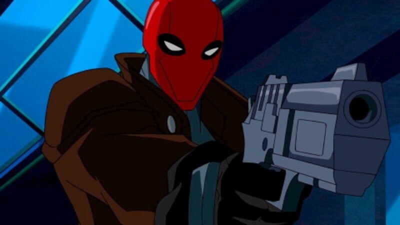 Red Hood pointing a gun at Batman