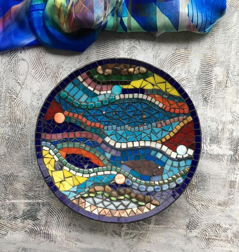 A plate with colourful glass pieces that create a vibrant mosaic 