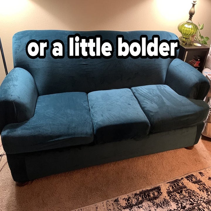 reviewer image of the blue stretch velvet couch cover on a large couch with text overlayed that reads "or a little bolder"