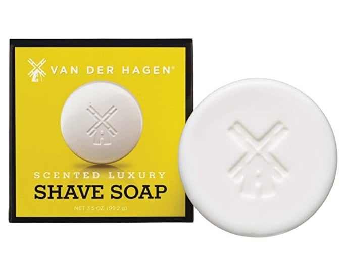 the bar soap box next to a round white bar with a windmill carved into it 