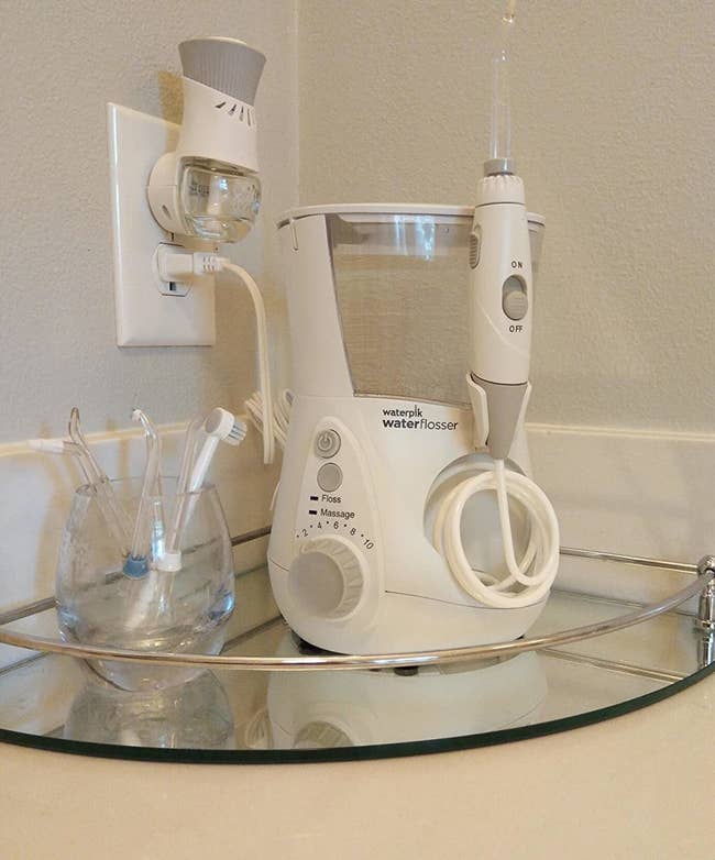 a reviewer photo of the WaterPik sitting on a mirrored tray 