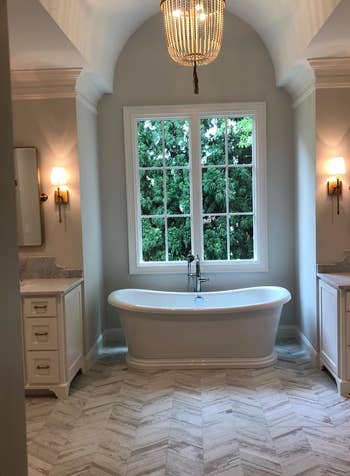 a chandelier hung over a reviewer's bathtub