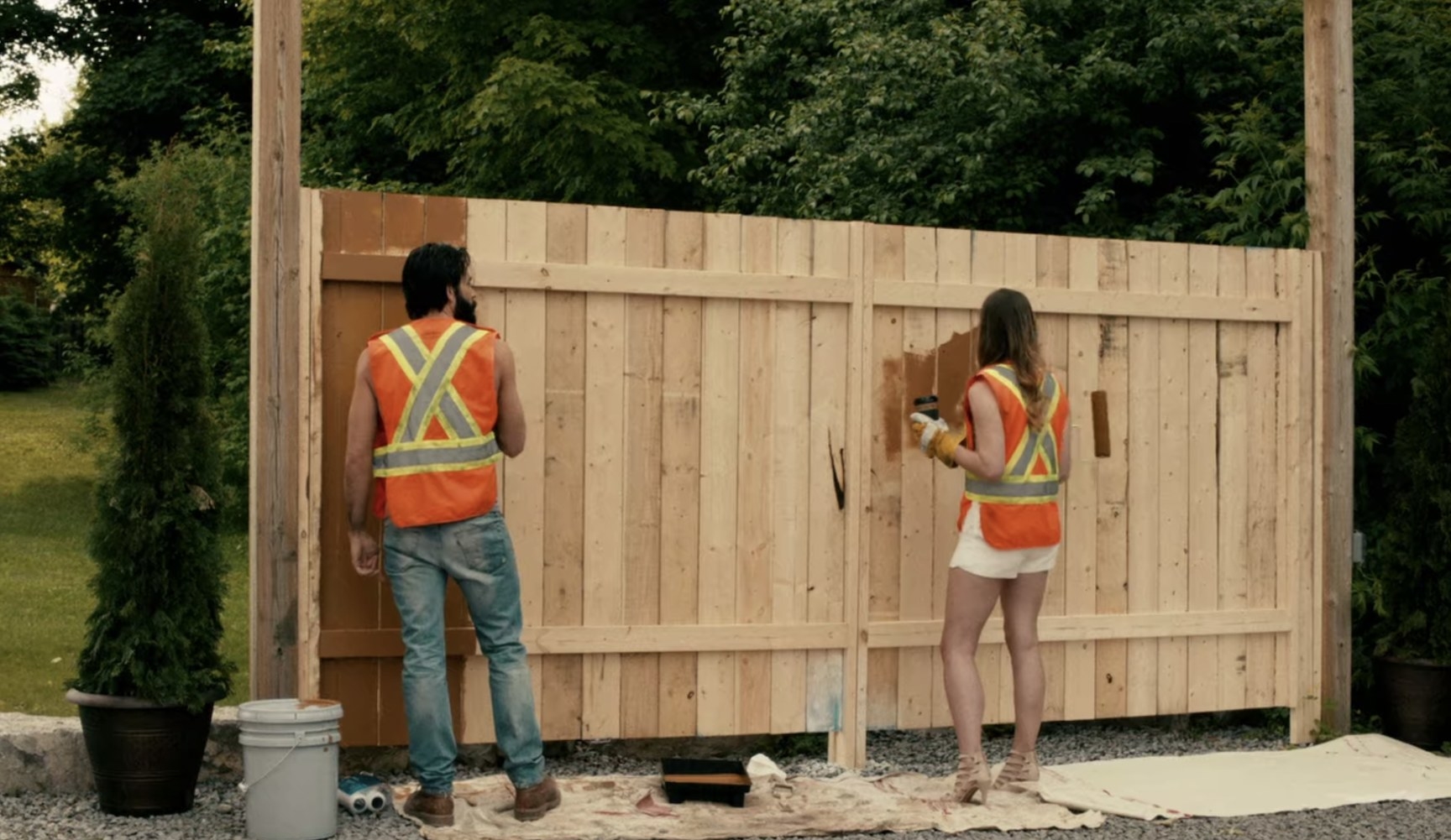 Alexis and Mudd painting fence