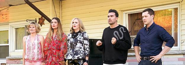 Schitt's Creek characters in front of motel
