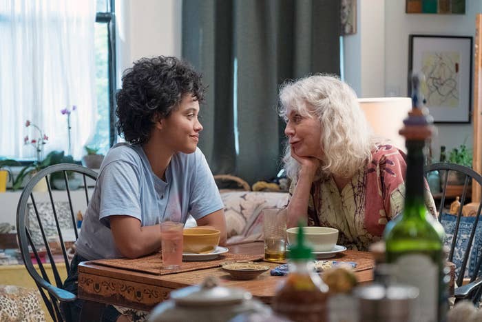 Kiersey Clemons and Blythe Danner sitting at the dining table and smiling at each other