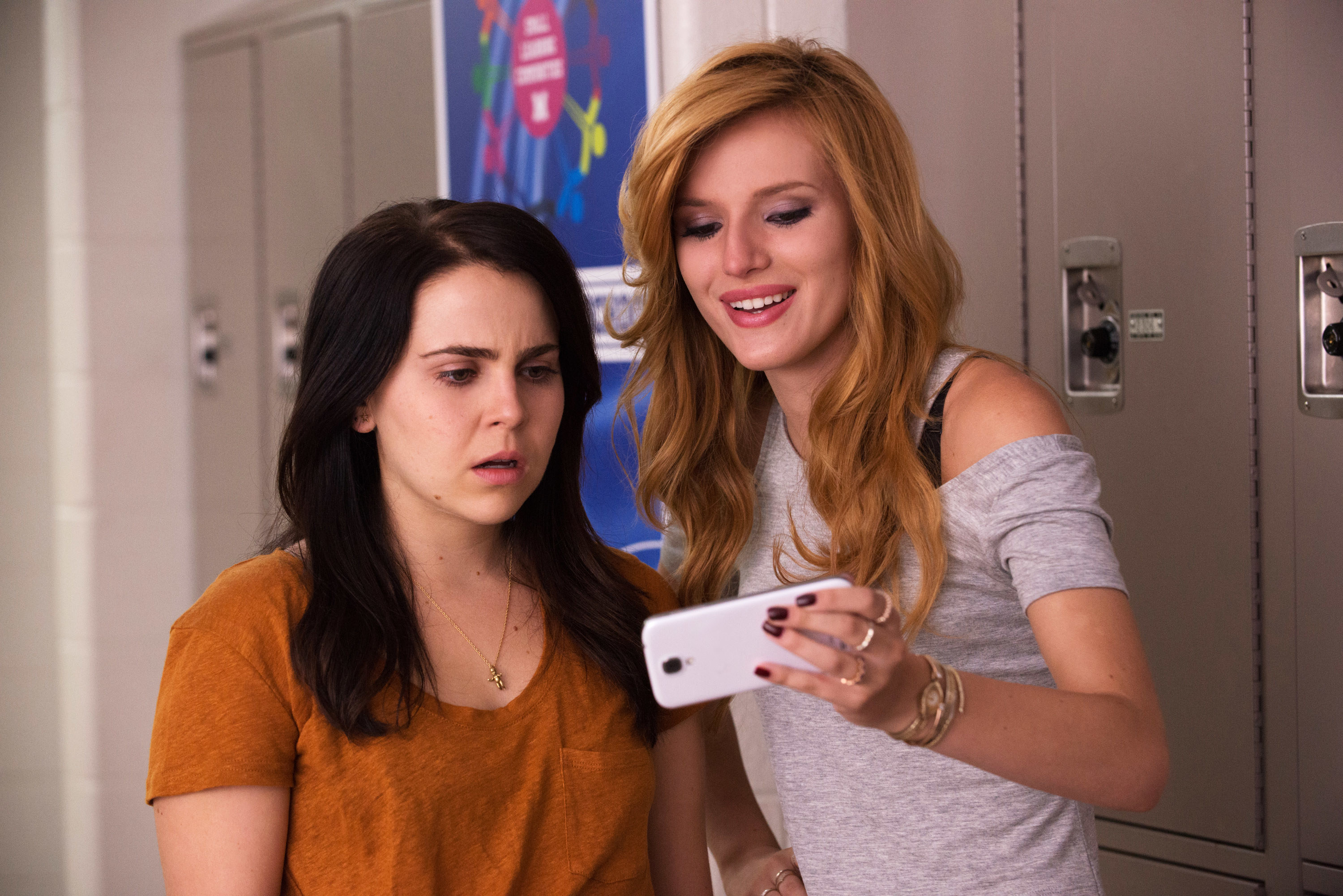 Mae Whitman and Bella Thorne looking at Bella&#x27;s phone while Mae looks shocked