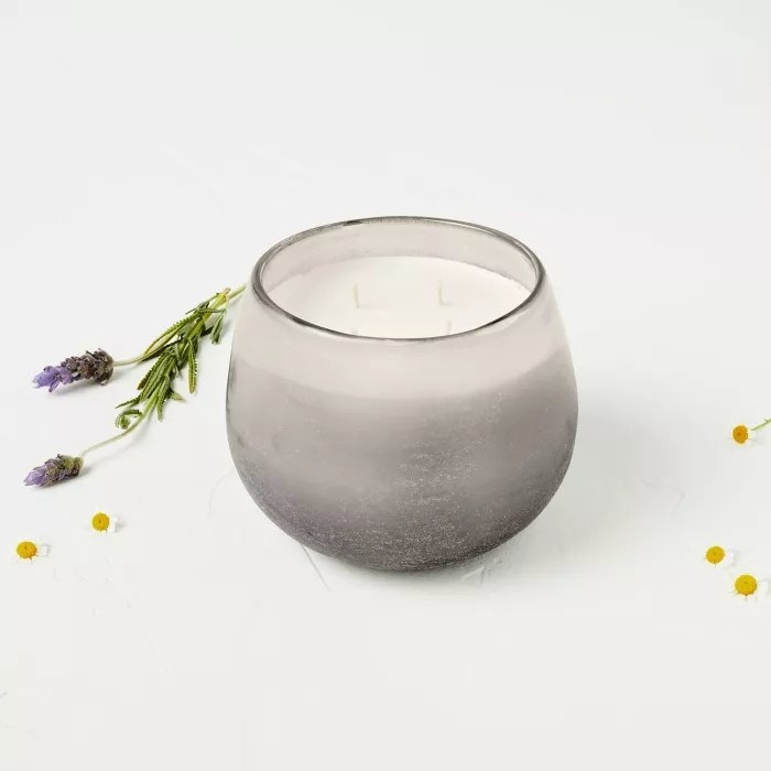 The wax candle in a frosted jar